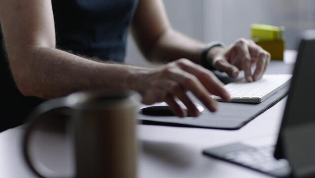 businessman working on laptop computer at home office. Male professional typing on laptop keyboard at office workplace

