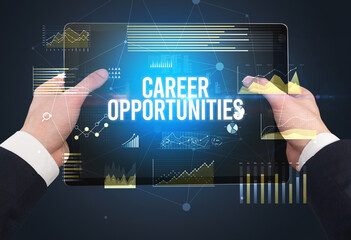 Close-up of hands holding tablet with business inscription