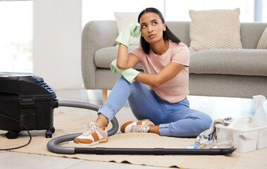 Do I have to do all this cleaning. Shot of a young woman sitting on the floor looking contemplative...
