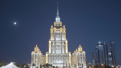 Large building with tower glows at night. Action. Beautiful large MSU building at night. Moscow University building glows at night