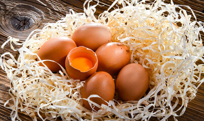 Composition with six chicken eggs on wood
