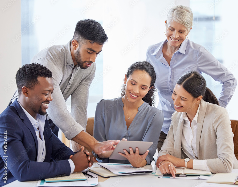 Poster collaboration is everything. shot of a group of businesspeople brainstorming and exchanging ideas in