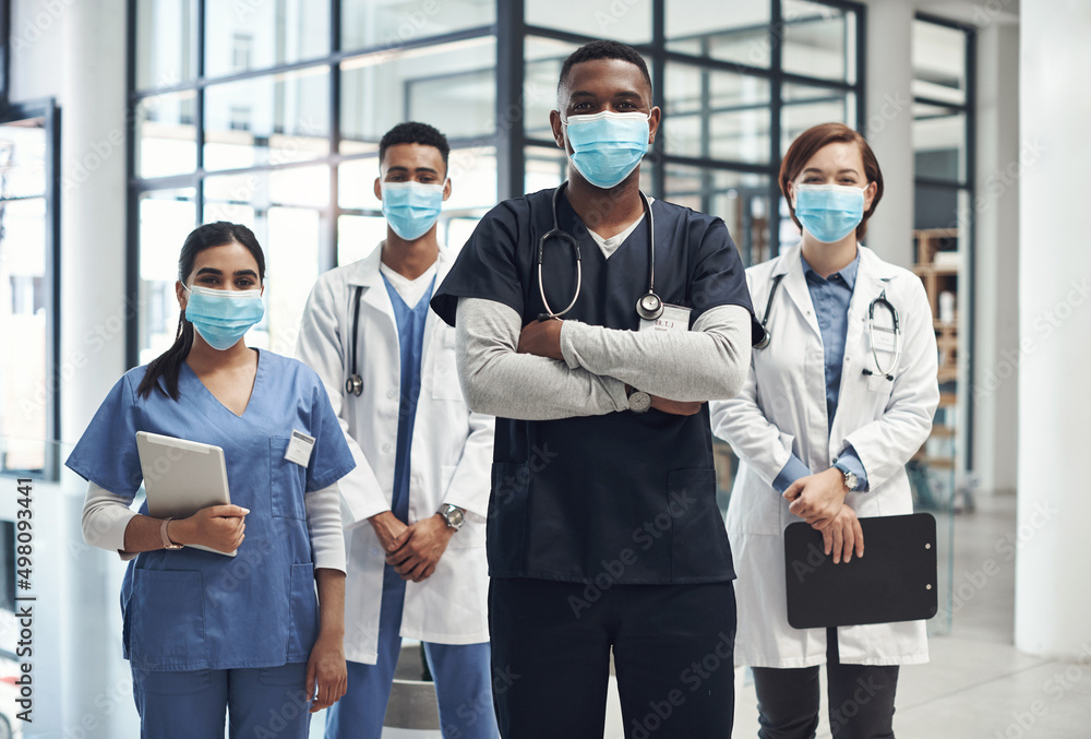 Poster its important to keep yourself protected. shot of a group of doctors and nurses wearing face masks t