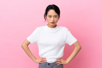 Young Vietnamese woman isolated on pink background angry