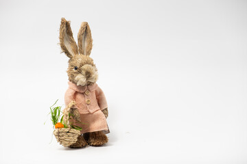 Easter Decorations Hare Rabbit of straw. Easter toy rabbit made of straw with a basket isolated on a white background