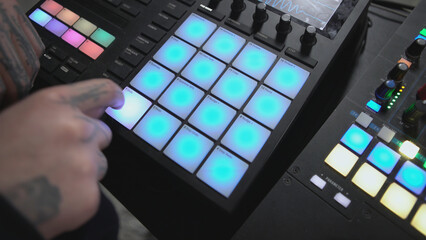 Click colored squares on mixer panel. ART. Hands in dark room are dialing code from multi-colored squares. Abstract music on mixer color board