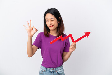 Young Vietnamese woman isolated on white background holding a catching a rising arrow and doing OK...