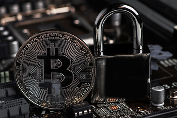Bitcoin with locker on motherboard. Cryptocurrency law. Digital security. BTC banned