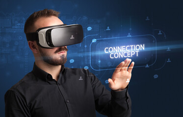 Businessman looking through Virtual Reality glasses, social media concept