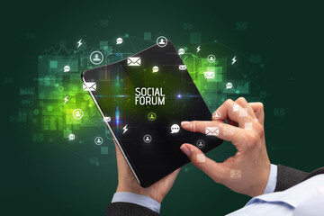 Businessman holding a foldable smartphone, social media concept