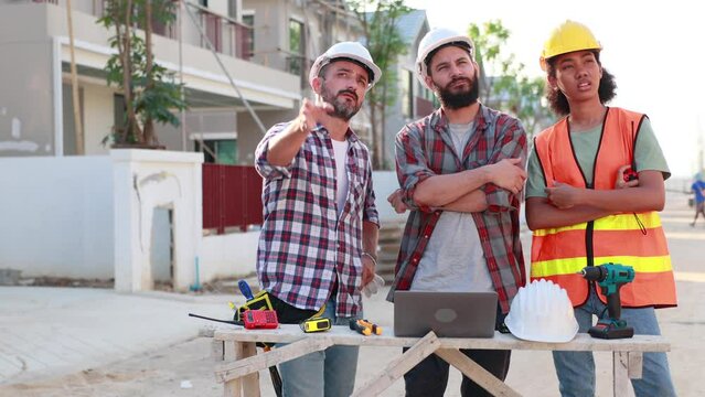 Slow motion VDO. Professional Mechanical Engineer and construction team at house project underconstruction site. Hands meeting together in line. Unity and teamwork concept.