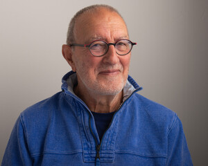 Obraz premium Close up portrait of a senior man on a grey background