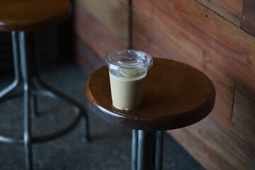 Closeup of Iced Caramel Macchiato at the coffee shop, Caramel Macchiato is a classic macchiato beverage. It consists of vanilla syrup, espresso, steamed milk, foam, and caramel drizzle