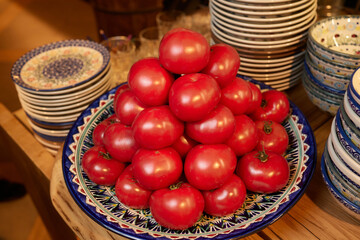 Fototapeta na wymiar ripe red cherry tomatoes on a clay plate.