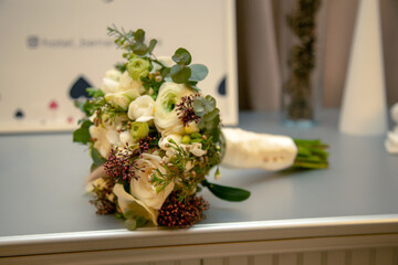 wedding bouquet of white and green flowers on the table