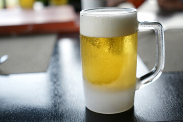 a glass of cold beer on the table in the restaurant
