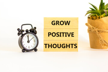 Grow positive thoughts symbol. Concept words Grow positive thoughts on blocks. Beautiful white...