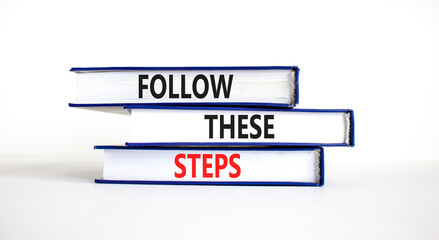 Follow these steps symbol. Concept words Follow these steps on books. Beautiful white table white background. Business and follow these steps concept. Copy space.