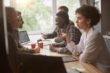 group of employees work in the hall of the coworking center. clo