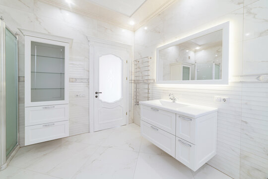 bathroom interior in light tone with mirror and shower