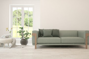 Fototapeta premium White living room with sofa and summer landscape in window. Scandinavian interior design. 3D illustration