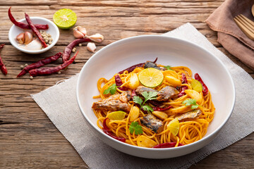 Spaghetti with Canned Mackerel and Dried Chili garlic in white plate.Fusion food