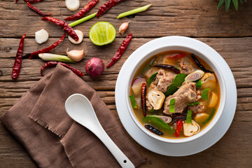 Spicy spare rib pork and straw mushroom,Fiery Pork Ribs Broth in white bowl.asian food.Top view
