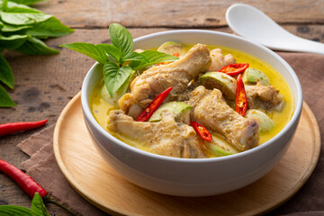 Thai Green Curry With chicken drumsticks in white bowl.asian food