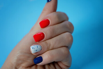 well-groomed, manicured fingers in vivid colors of the hand