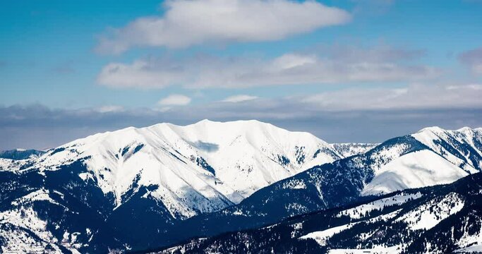 Clouds casting shadows over icy mountain range in romania borsa