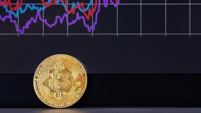 Coin Bitcoin close-up, and schedule the exchange in background.