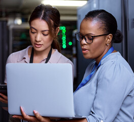 Running diagnostics. Cropped shot of two attractive young female computer programmers working...
