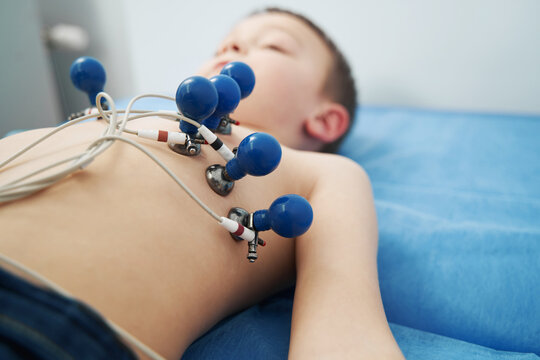 Little boy undergoing electrocardiogram test in clinic