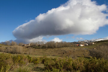 Obraz na płótnie Canvas Mountain town of La Lastra with a big cloud in the sky , Palencia, Spain 