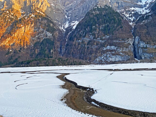 The confluence of the alpine stream Sulzbach into the accumulation lake Klöntalersee...