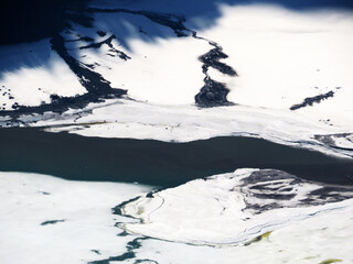 The confluence of the alpine stream Sulzbach into the accumulation lake Klöntalersee...