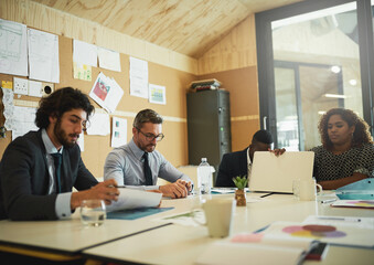 Lets think about this everyone. Cropped shot of a group of coworkers having a meeting in the office to discuss ideas and future business propositions.