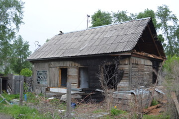 Abandoned burnt-out old wooden individual residential building