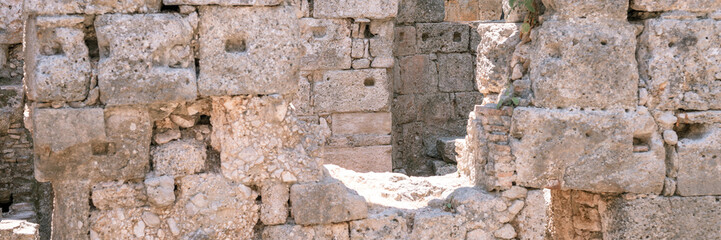ruined construction of the old stone building. explore the ancient excavations of the ruins of the...