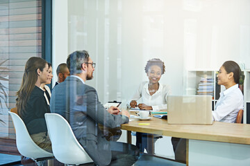 Open lines of communication. Cropped shot of a group of businesspeople meeting in the boardroom.