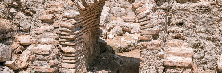 ruined construction of the old doorway building. explore the ancient excavations of the ruins of the ancient Lycian city of Phaselis in Turkey in summer nature in the mountains outdoor. banner