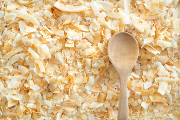 toasted coconut flake with wooden spoon - obrazy, fototapety, plakaty