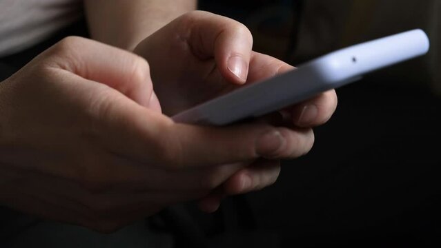 Woman hand holding cell phone touch screen typing scroll page using app. Smartphone mobile phone device in hands. Internet news content apps cellphone addiction concept