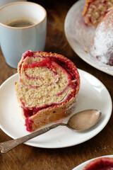 Raspberry roll wreath. Brioche. Side view, wooden background, coffee, powdered sugar, yeast buns. 