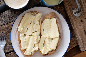homemade bread with butter on a wooden background. exit from above