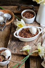 Crumble with apple and chocolate. Narcissus, ice cream, wood background, side view, vensa.
