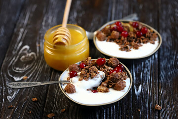 Healthy breakfast. Chocolate crunches with yogurt, honey and berries.