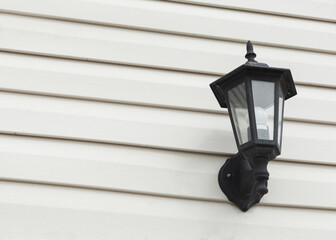 lantern hanging on the facade of the building during the day
