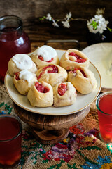 Buns with cherry and cream sauce. cherry compote. side view.