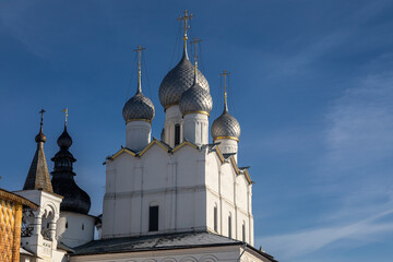 Beautiful church with domes against the blue sky. Winter sunny day. Colorful light. Ancient architecture. Cross on domes.